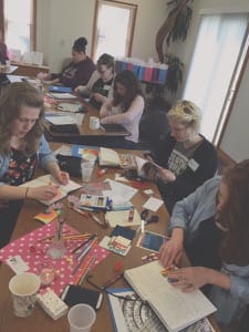 Bethel College students work on an art exercise, part of the faith formation portion of the Sister Care for College Women day that took place earlier in the semester.