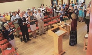 Rachel Unruh ’13 leads the singing at the Alumni Weekend worship service and Heritage Roll of Honor memorial service last June.