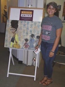Freshman Akiyaa Hagen-Depusoir with the painting she displayed as part of #PieceUnited at Kauffman Museum