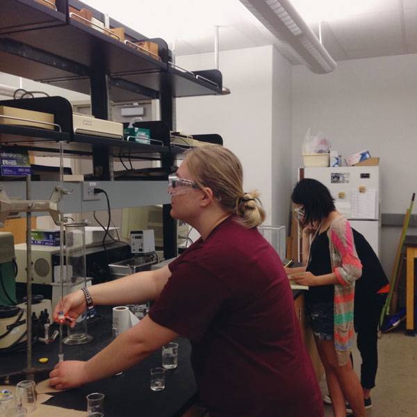Amber Schmidt-Hayes, left, works at measuring solubility in a chemistry lab at the University of North Texas in Denton, where she is spending the summer in an undergraduate research program sponsored by the National Science Foundation.