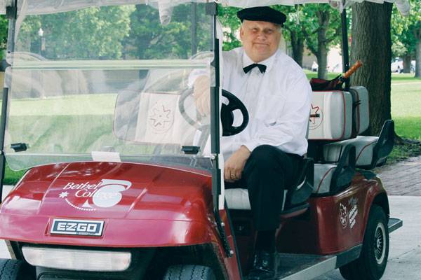 Fred Goering cheerfully chauffeured people around campus in the Bethel College “limo,” and always dressed the part.