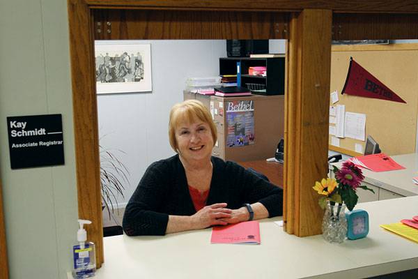 This is the view that many generations of students had of Kay Schmidt, associate registrar for 27 years, greeting them with a smile at the registrar’s office window.