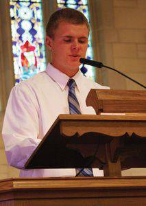 Jared Regehr offers a prayer at Baccalaureate.  Photo by Vada Snider.