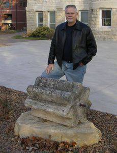 Glen Ediger ’75, pictured here with the Ad Building threshing stone, notes that telling the stone’s story requires consideration of 'international politics, the opening of the Wild West, the railroad, the search for religious freedom,' plus archaeology, evolution, changes in world food supplies and farming technology, and ancient to modern history. Much like a liberal arts education.
