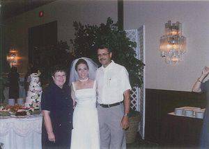 Delora and Jerry Decker with Susan Peschel Deraney on her wedding day, Aug. 19, 2000.