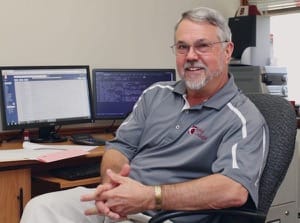 Tony Graber with the computer screens and numbers that were an integral part of his job at Bethel for the past 22 years.