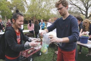 Matt Rodenberg helps Xi Cheng create her tie-dyed “Bethel Pride” T-shirt as part of the activities during the spring Pride and Inclusion Week on campus.
