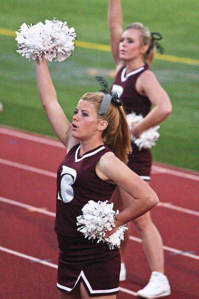Freshmen Brenna Kleman, Derby, front, and Erin Ferguson, Sterling, members of Bethel’s brand-new cheer squad, encourage the fans during the Fall Festival football game against Sterling College.