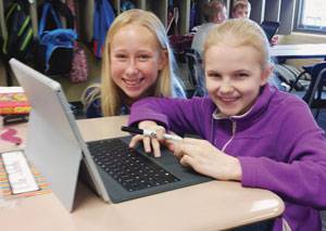 Two of Todd Flory’s 4th-grade students, Haley DeVaughn, left, and Ella Jahnke, Skyping® with a 4th-grade class in North Carolina to review math concepts.