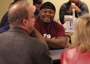 Sheldon Nunnally engaging in lunchtime discussion with Hamilton Williams and Marla Krell.  Photo by Vada Snider.