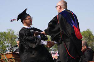 Arthur Kauffman accepts his diploma from Brad Born.  Photo by Vada Snider.