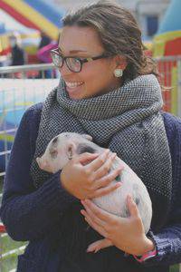 Kimberly Buzbee meets a very young pig