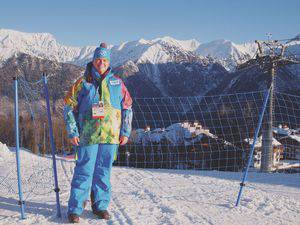 Allison McFarland poses in front of one of her favorite views, the mountains near Sochi, Russia, wearing her official Sochi Olympics volunteer gear, which she fondly called her 'Smurf outfit.'