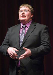 Henry Unruh giving a speech in Krehbiel Auditorium.  Photo by Craig Hacker.